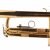Close-up of trumpet tubing, third-valve slide ring, and tuning slide with visible finish wear. card