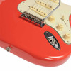Close-up of chrome tremolo bridge, cream controls, and recessed output jack on Fiesta Red Stratocaster. card