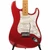 Close-up front view of Candy Apple Red Stratocaster body with pearloid pickguard, three single-coil pickups, and tremolo bridge.