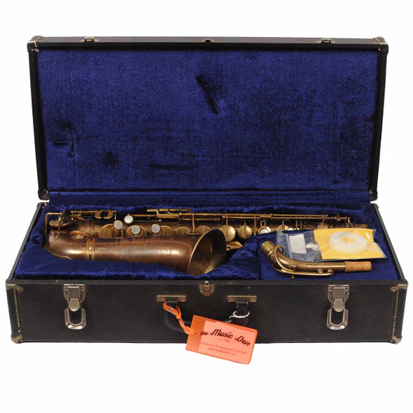 Vintage alto saxophone with neck and accessories in an open blue-lined hard case. card