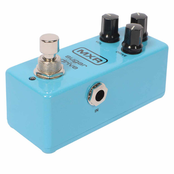 Low-angle view of the MXR Sugar Drive overdrive pedal showing the footswitch, input jack, and three control knobs. card