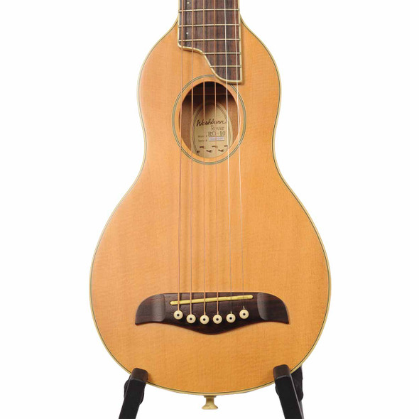 Front close-up of the Washburn Rover RO10 travel acoustic guitar showing the spruce top, soundhole, bridge, and strings.