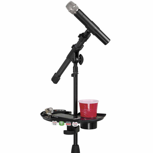 Clamp-on microphone stand accessory tray mounted below a microphone, holding a drink, phone, keys, and guitar picks with integrated cup holder. card