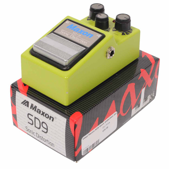 Three-quarter view of the Maxon SD9 Sonic Distortion guitar effects pedal displayed on its original product box. card
