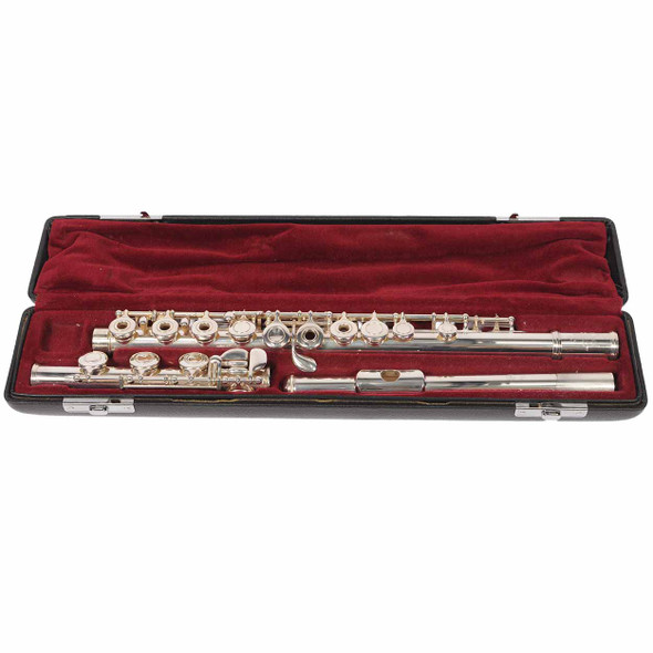 Yamaha YFL-461II flute disassembled into three sections inside a black case with red plush lining. card