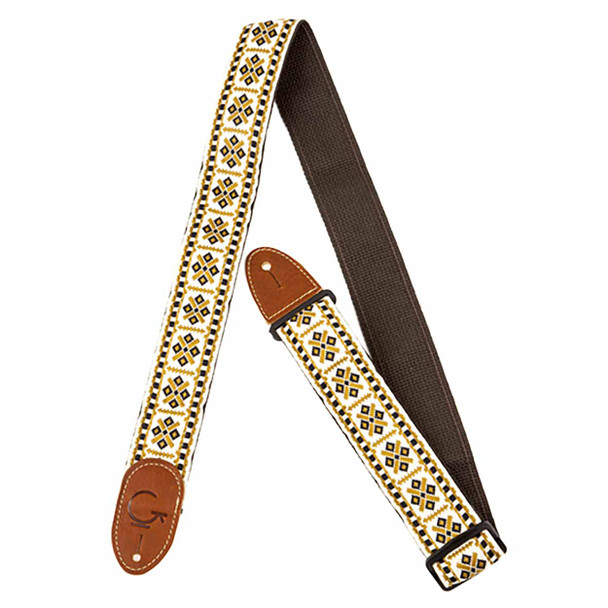 White woven guitar strap with black and gold geometric embroidered pattern, brown web backing, and brown leather ends. card