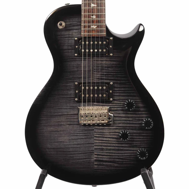 Close-up front view of PRS SE Tremonti electric guitar body with black figured top, dual humbuckers, tremolo bridge, and four control knobs. card