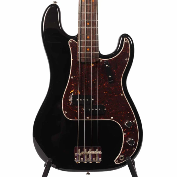 Close front view of the black Precision Bass body with tortoiseshell pickguard, split-coil pickup, bridge, and controls. card