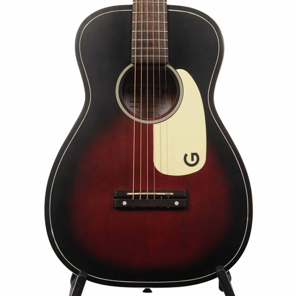 Close-up of Gretsch Jim Dandy parlor guitar with Deep Cherry Burst finish, white pickguard, and walnut bridge. card