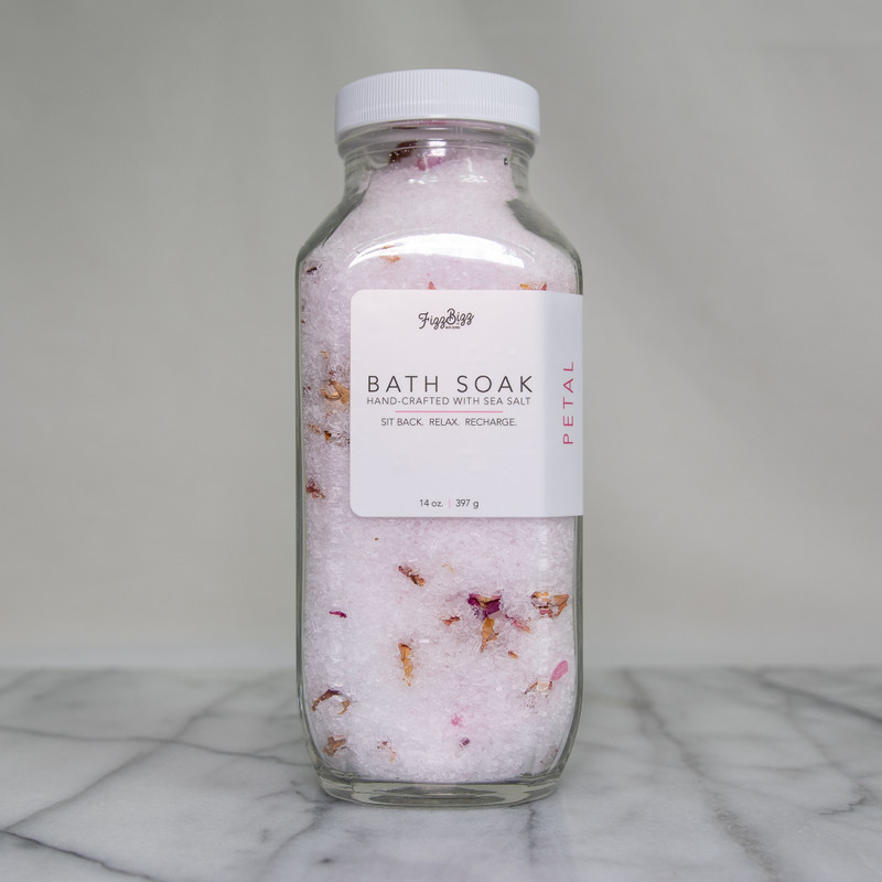 The front view of our Petal premium bath salts. A 14 oz jar of bliss in a bottle. 