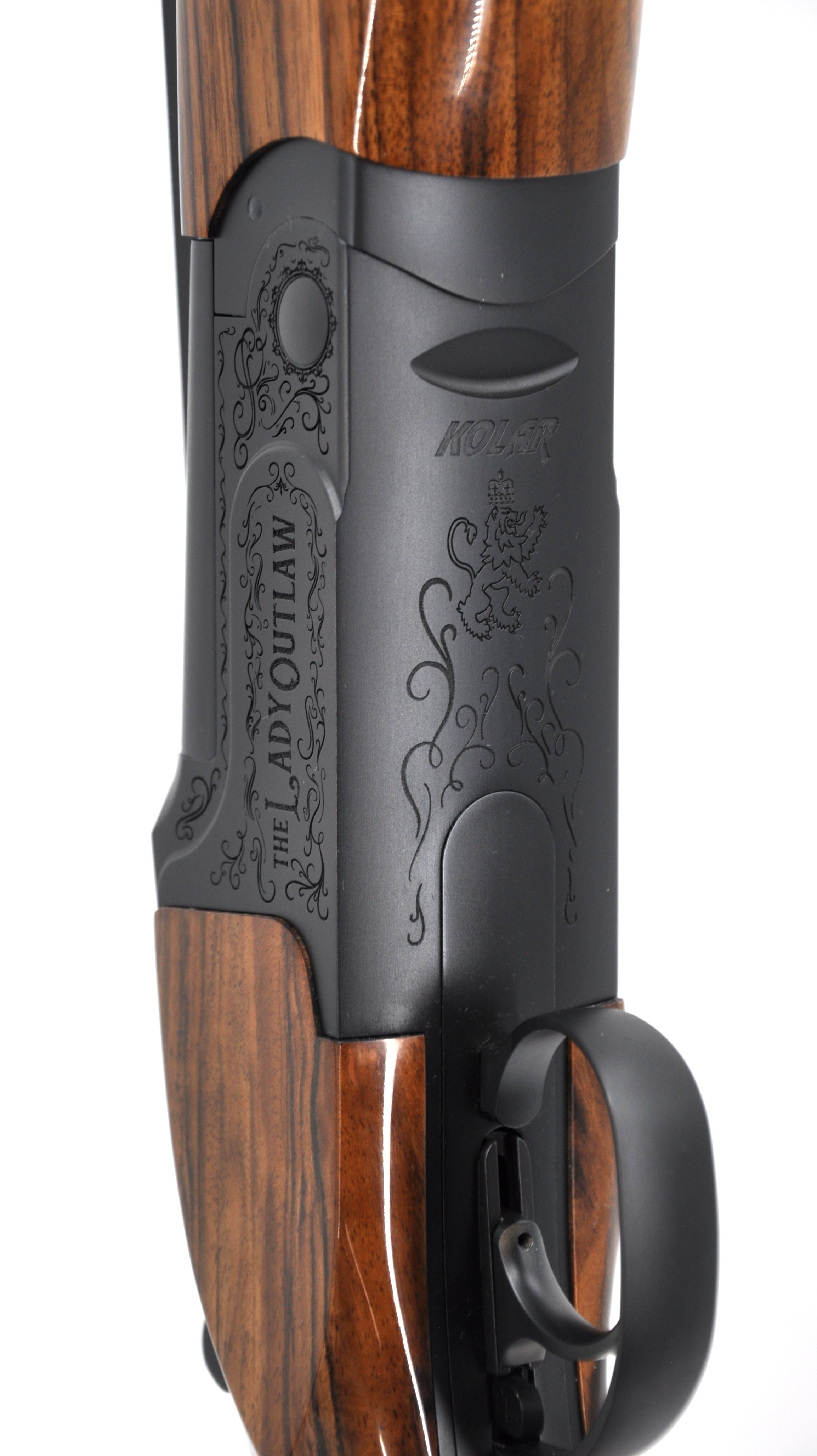 Lady Outlaw shotgun detail with elegant engraving and upgraded wood