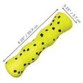 Bright Yellow with black dots bone-shaped dog toy with raised bumps.  Shown with product dimensions