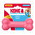 Pink bone-shaped dog toy with textured ends. Shown in its retail packaging.