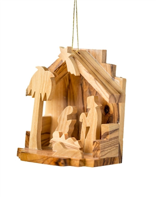 Image shows a small Nativity with a palm tree made from olive wood.
