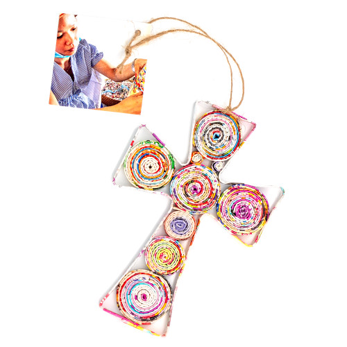 Image shows a handcrafted cross ornament made from recycled magazine paper and created by artisan collectives in Vietnam.