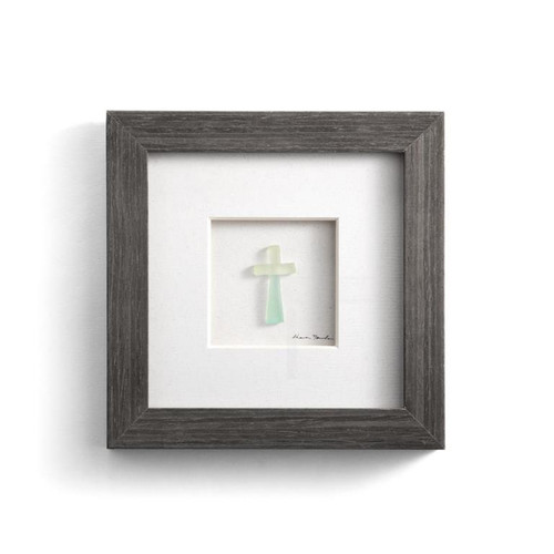 Image shows a handcrafted cross measuring 6 inches square. This piece features a minimalist cross design composed of composite pebbles and mixed media, set against a soft gray backdrop.