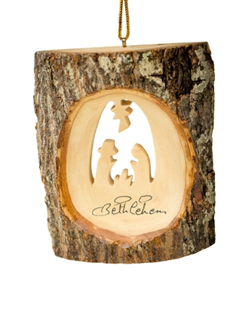Image shows a handcrafted Nativity ornament carved into a piece of authentic olive wood bark.