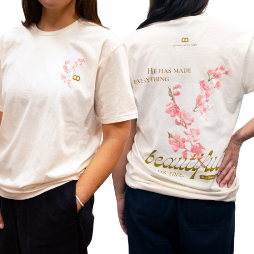 The image shows the front and back of this cherry blossom branch t-shirt in cream.