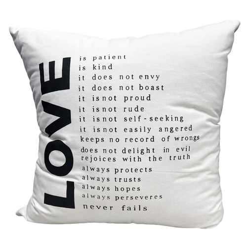 The image shows the pillow with the words of 1 Corinthians 13. 