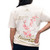 The image shows the back of this cherry blossom branch t-shirt in cream.