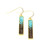 The images show a pair of  Explorer earrings made with earth from Qurman and turquoise stones.  