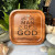 The image shows the "Man of God" trinket dish surrounded by seashells and greenery.