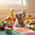 The image shows a view of an elephant plush on the floor near toys.