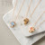 The image shows several cross necklaces on a flat surface. 