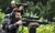 shooter and spotter shown using a rifle on a bag over an obstacle. rifle is in MDT JAE-G5 Chassis