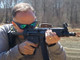 Century AP5 pistol (9mm) from MKE - HK MP5 clone shown being fireed by man