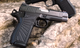Wilson Combat SFT9 4.25" 9mm Pistol 15-Round - Black shown on rocks