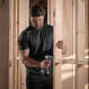 Tradesman using impact driver on construction site wearing Black Scruffs Trade Tech Moisture Wicking T-Shirt