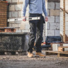 Scruffs Trade Holster Trousers worn by builder carrying spirit level on site