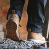 Rear view of Scruffs Ridge tan safety boots being worn on site, showing the deep patterned tread outsole