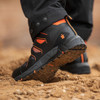 Scruffs Glide Safety Boots Ã¢â‚¬â€œ boots worn on sandy ground showing flexible tread