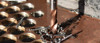 Close-up of brown ULTRA imperial coated drill bit cutting into thick steel plate