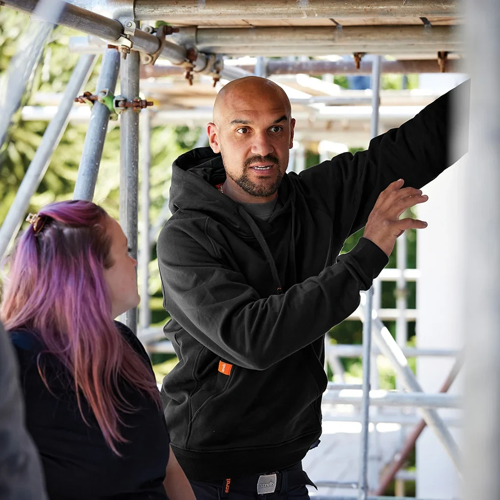 Scruffs Worker Hoodie black worn on construction site showing comfortable hooded workwear fit
