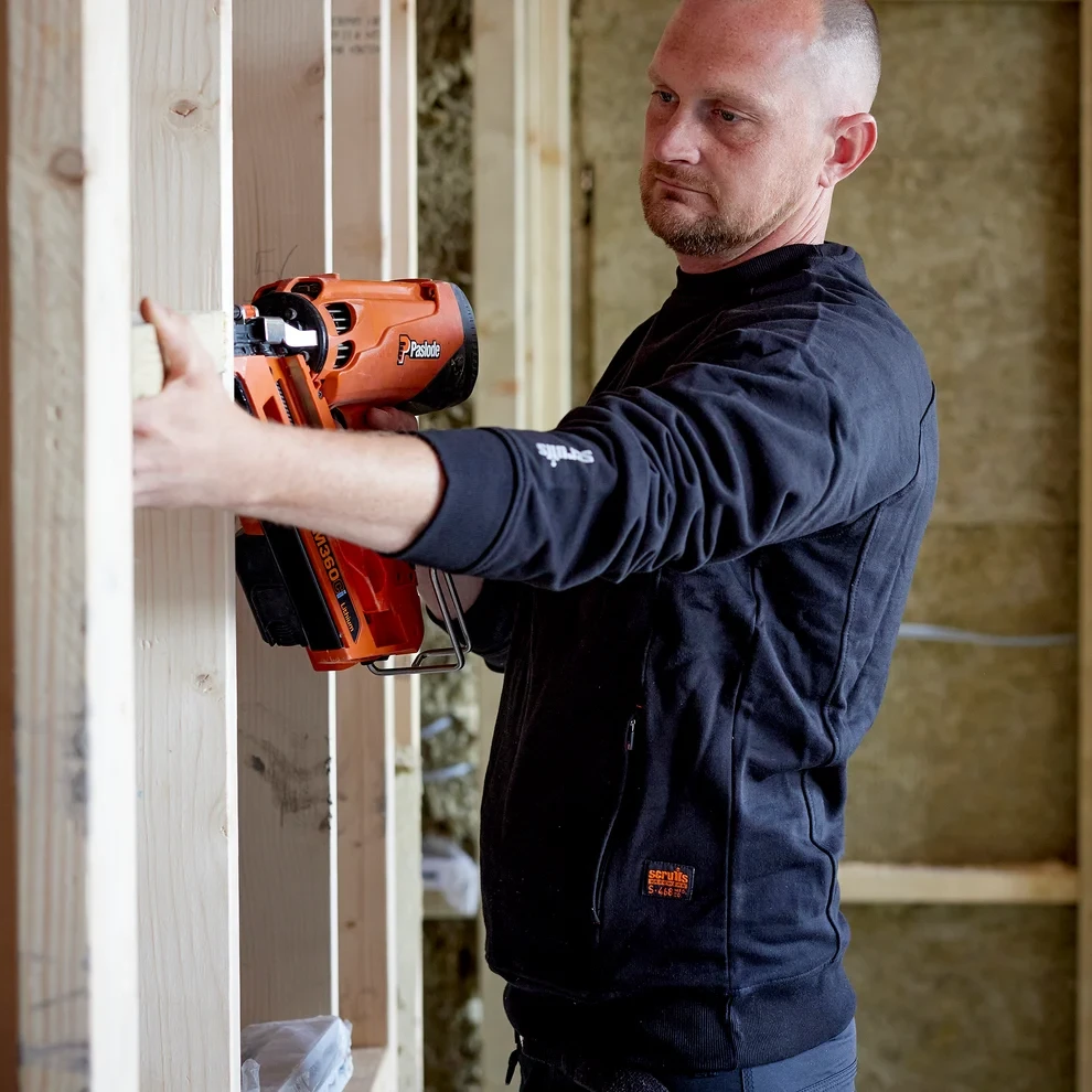 Scruffs Worker Sweatshirt navy worn by tradesman on construction site with durable crew neck workwear design