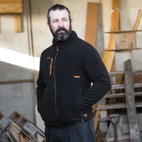 Scruffs Abratect Fleece worn by tradesperson in workshop showing full zip and zipped chest pocket