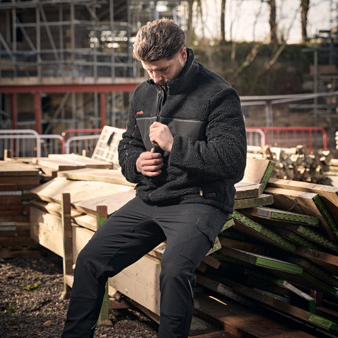 Scruffs Borley Sherpa Fleece worn by tradesperson on site showing high collar and warm fleece construction