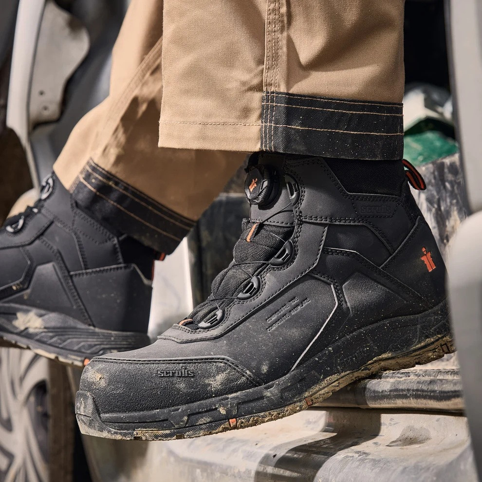 Scruffs Vault Twist and Lock Safety Boot Ã¢â‚¬â€œ black twist-and-lock safety boots worn on a worksite