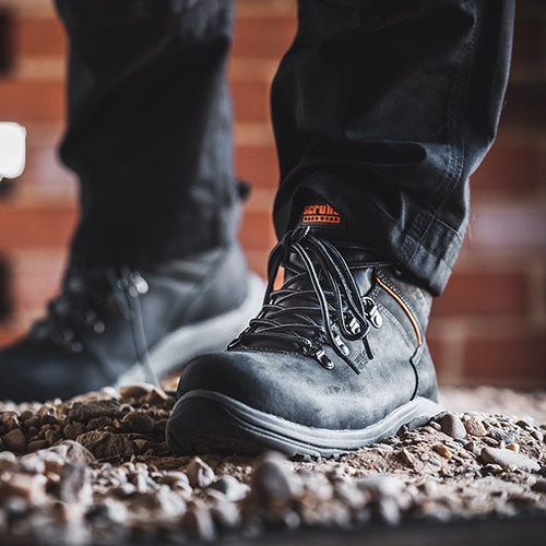 Scruffs Rafter Safety Boots Ã¢â‚¬â€œ black safety boots worn on rubble in front view