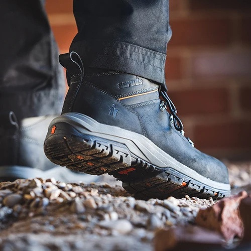 Scruffs Rafter Safety Boots Ã¢â‚¬â€œ black safety boots worn on rough ground showing outsole
