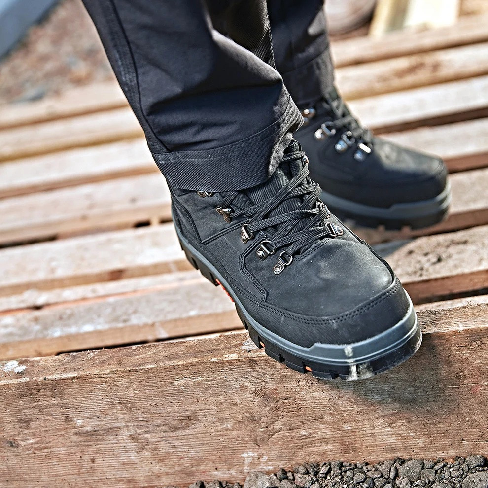 Scruffs Rugged Safety Boots Ã¢â‚¬â€œ black safety boots worn on timber at a worksite
