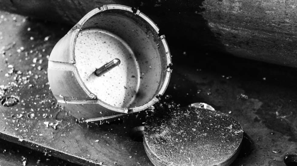 HMT CarbideMax 55XL TCT Magnet Broach Cutter – close-up of a drilled steel hole and extracted metal slug