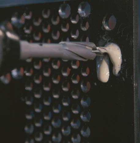 HMT Speedlube Drilling & Tapping Spray Aerosol – spray lubricant being used on perforated metal