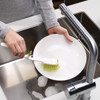 Green Joseph Joseph Edge Dish Brush in use