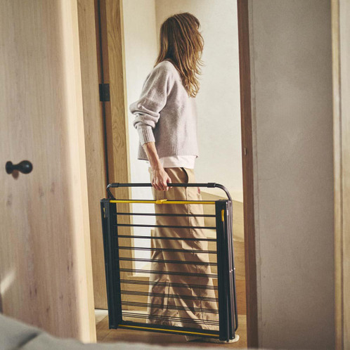 Black Joseph Joseph AirFrame Max 21m 3-Tier Clothes Airer Being Carried