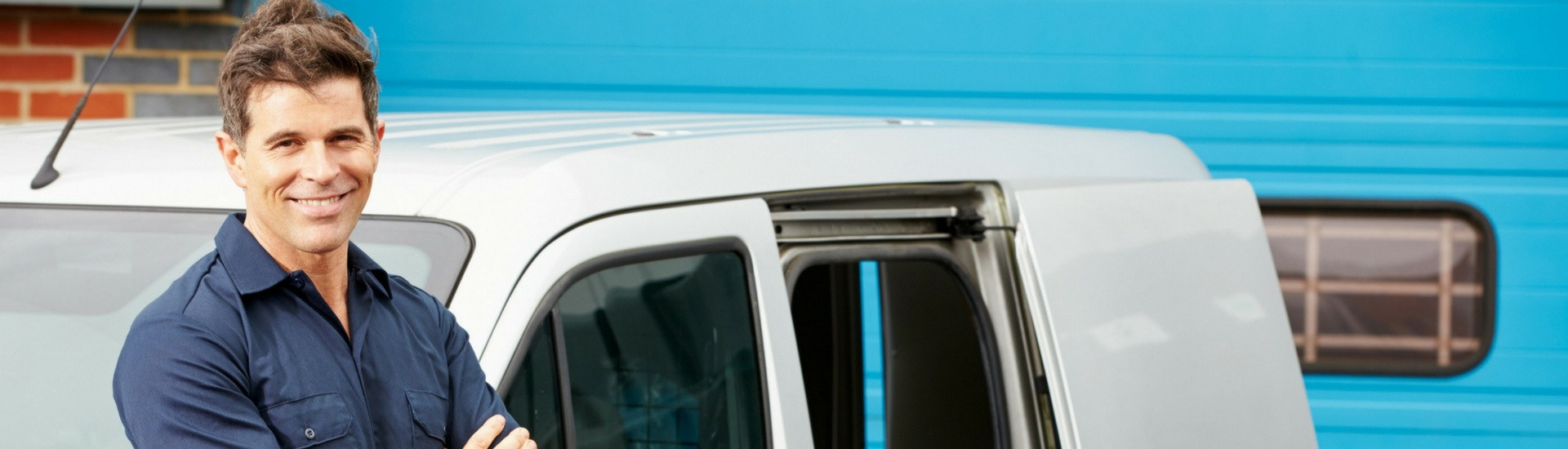 Sign Repair Technician In Front of Service Van 