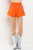 Bright orange short with rhinestone details and matching top